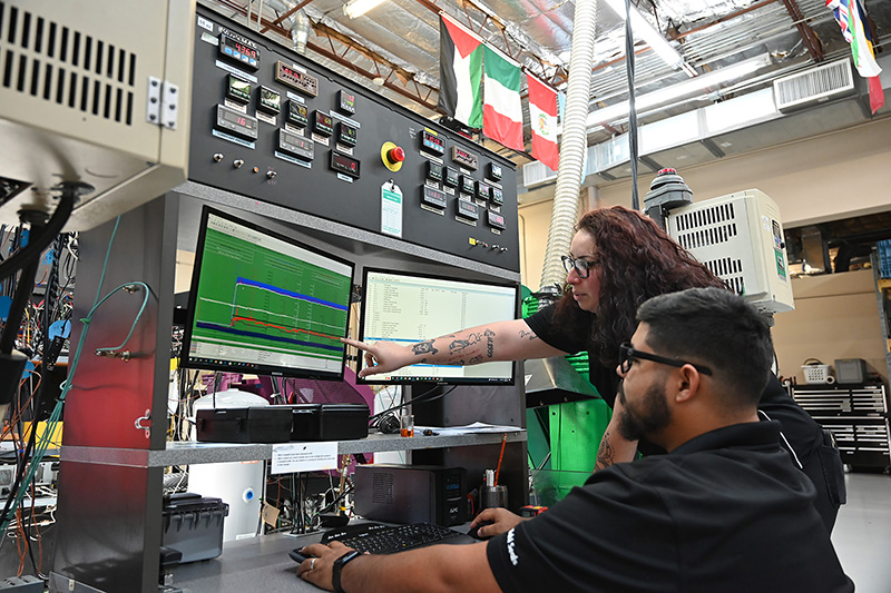 Two technicians at work in the Kalsi Engineering seal testing lab.
